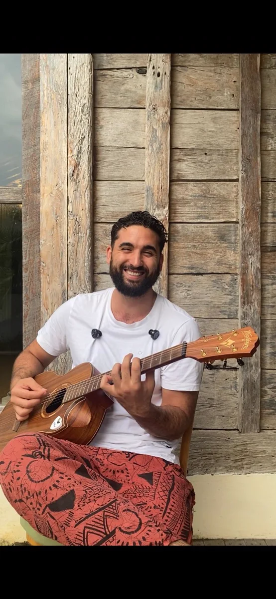Dan Maccaba playing guitar