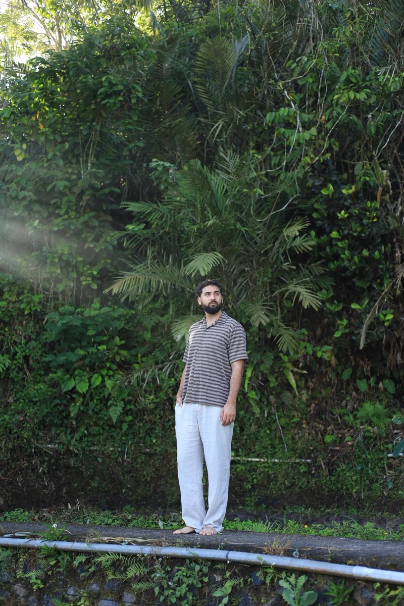 Dan Maccaba standing in greenery